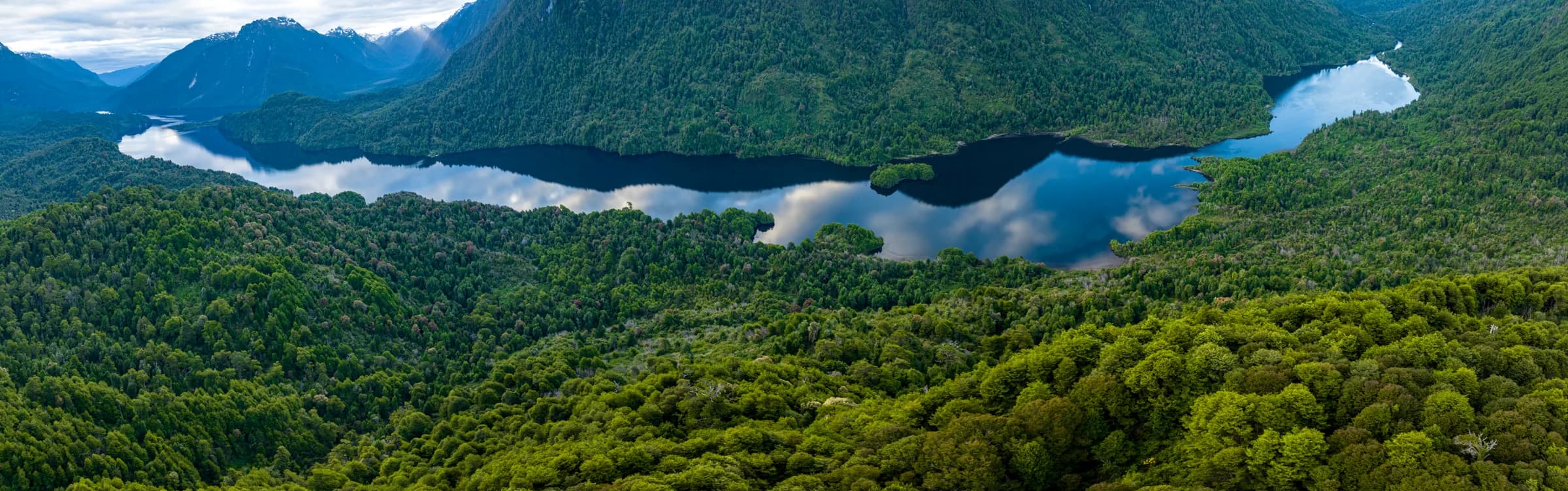 High aerial of the lake threading through the wild Patagonian valley